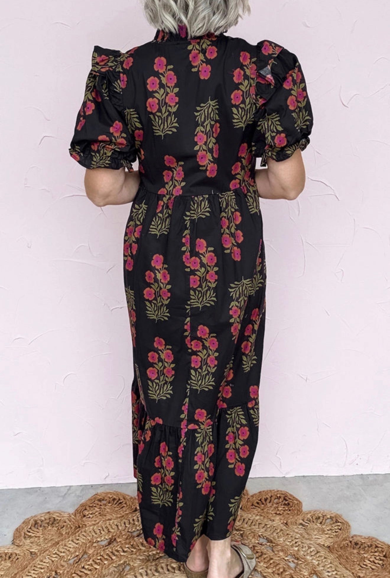 Long black dress with floral print, short puff sleeves and layers