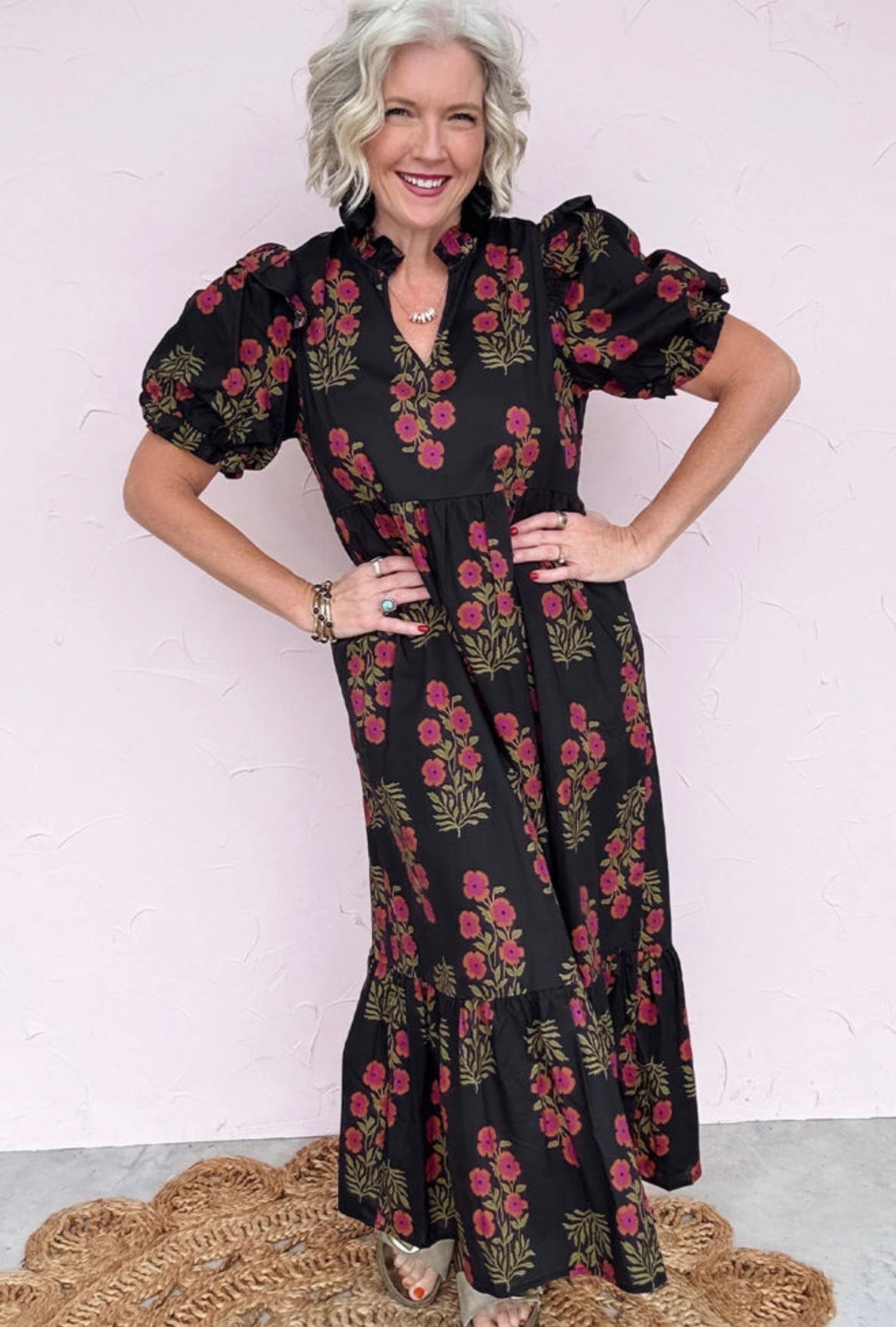 Long black dress with floral print, short puff sleeves and layers